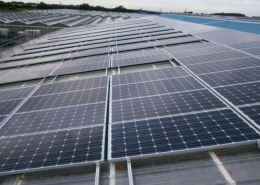 solar panels sitting on a rooftop of a factory